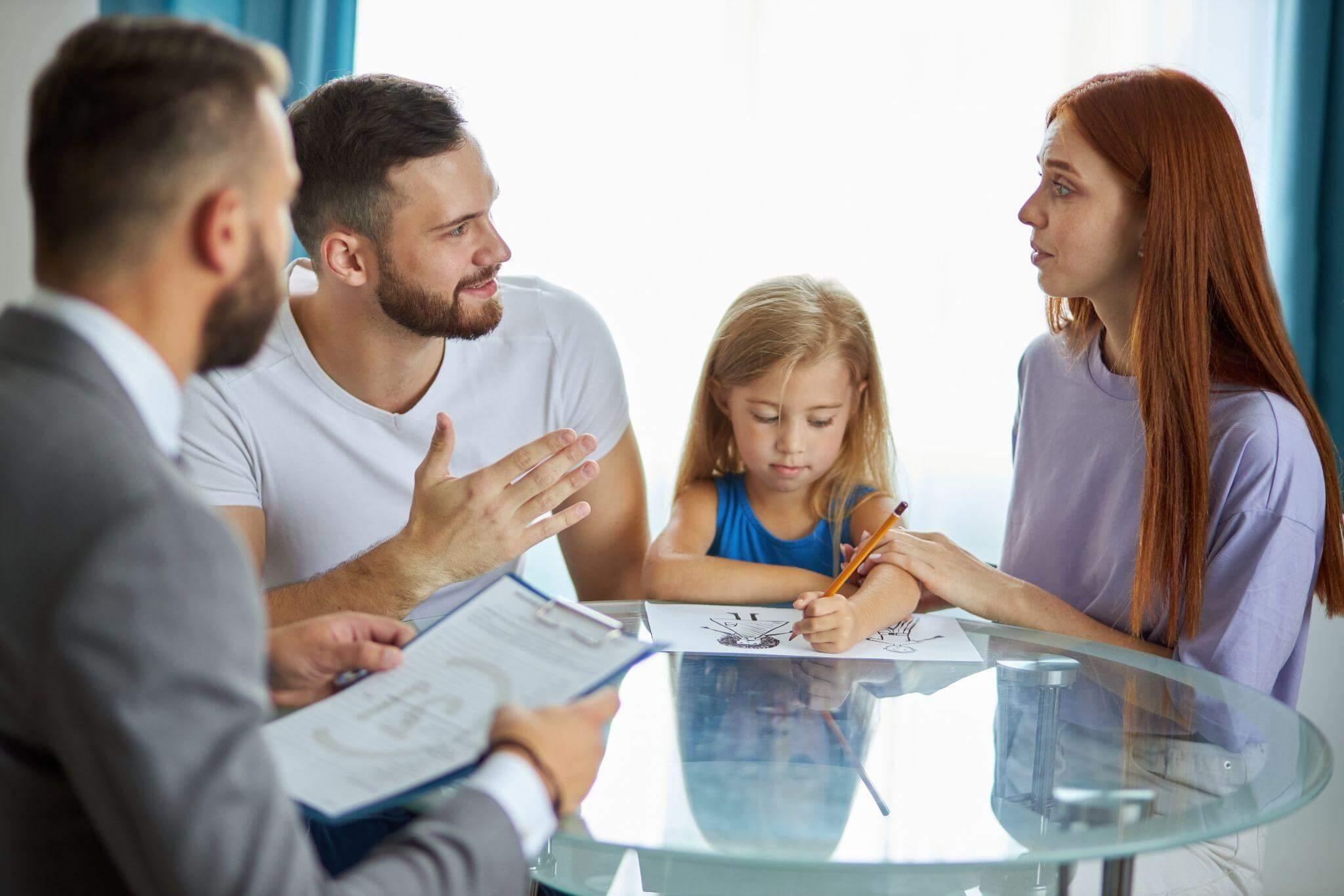 a group of people sitting around a glass table